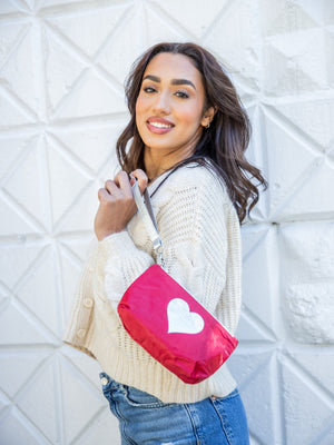 Light and on-the-go zip wristlet in crimson red with a silver heart