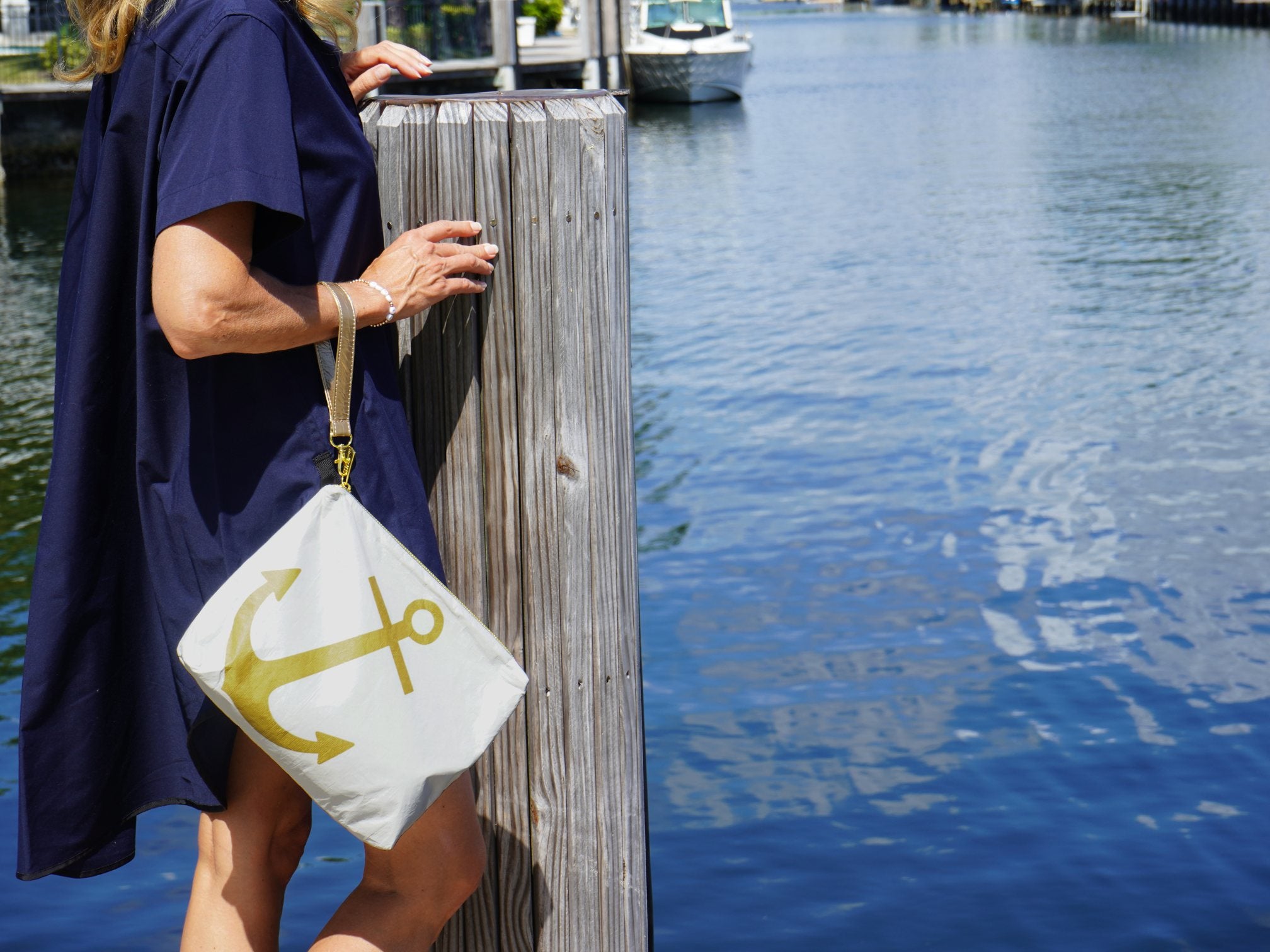 white zipper clutch with gold anchor