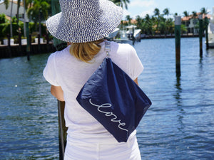 zipper clutch purse in navy with nautical white rope