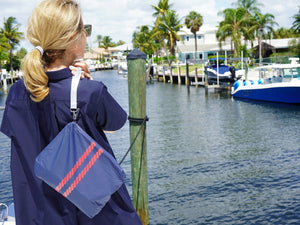 navy blue handbag with red stripes in water resistant fabric